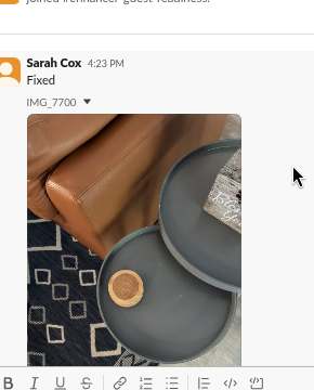 Slack post: living room tray styled on a leather ottoman, captioned 'Fixed'